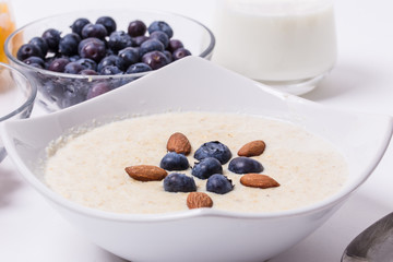 Bowl of oatmeal porridge with walnuts  and blueberry