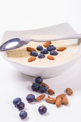 Bowl of oatmeal porridge with walnuts  and blueberry