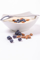 Bowl of oatmeal porridge with walnuts  and blueberry