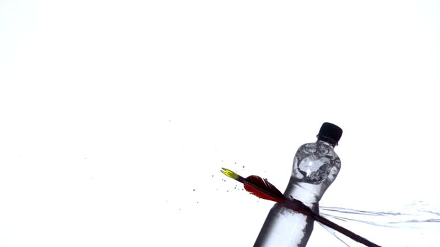 Arrow shooting through plastic bottle
