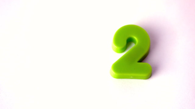 Number two falling onto white surface