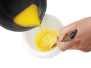 Melted butter from kettle into egg yolk mix