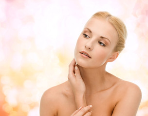 Naklejka premium beautiful woman touching her face skin