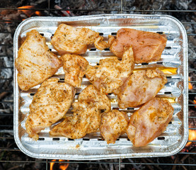 Grilling chicken breast on barbecue grill