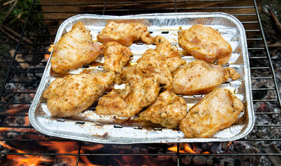 Grilling chicken breast on barbecue grill