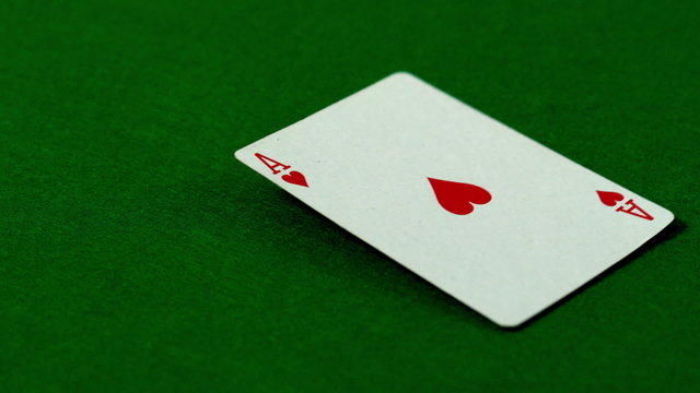 Ace of hearts falling on casino table
