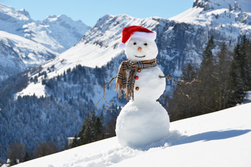 Snowman against Alpine panorama