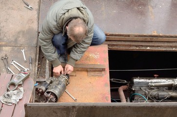 The man repairing a starter boat