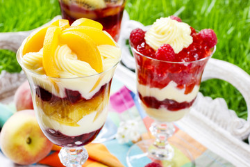 Layer fruit desserts on wooden tray. Summer garden party