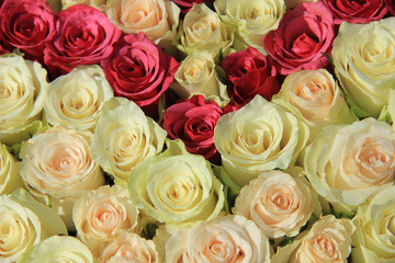 Pink roses in different shades in wedding arrangement