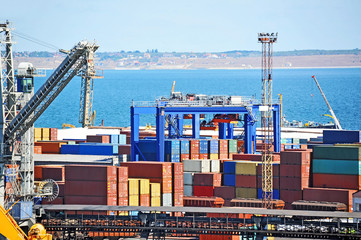 Port cargo crane and container over blue sky background