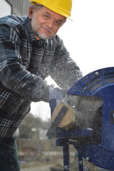 Rentner sägt mit Kreissäge