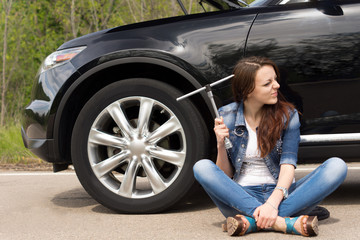 Perplexed woman waiting for roadside assistance