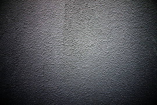 Old cement wall texture of dark color.