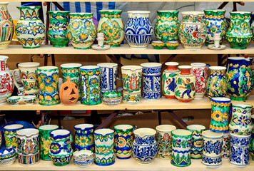Colorful ceramic jugs on the shelf