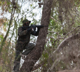 man with a gun on a tree meets the enemy