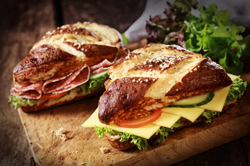 Lye bread rolls with cheese and salami