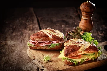 Foto op Canvas Crusty brown lye bread roll sandwiches © exclusive-design