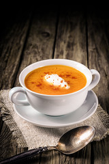 Obraz na płótnie Canvas Delicious spicy carrot soup with cream