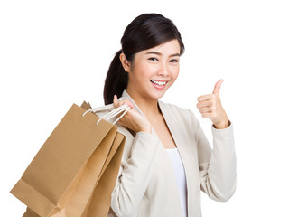 Woman with shopping bag and thumb up