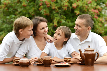 Happy family drinking tea