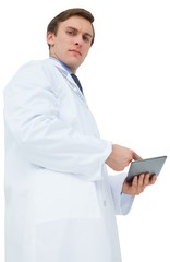 Young doctor in lab coat using tablet pc