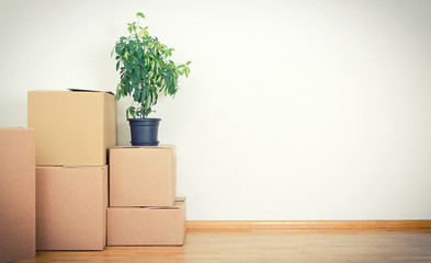 New home concept. Boxes in empty room.