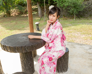 Asian woman wearing a kimono in Japanese garden