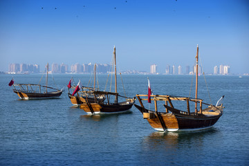 Fototapeta na wymiar Boats on a background of a modern city in doha
