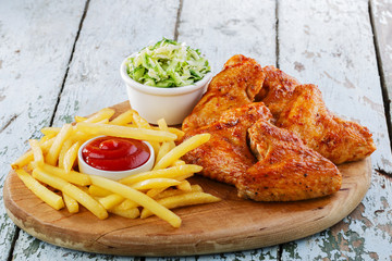 fried chicken wings with french fries - 64906696