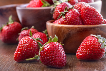 healthily raised organic strawberries in a wooden bowls