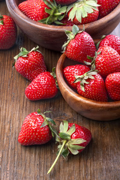 healthily raised organic strawberries in a wooden bowls