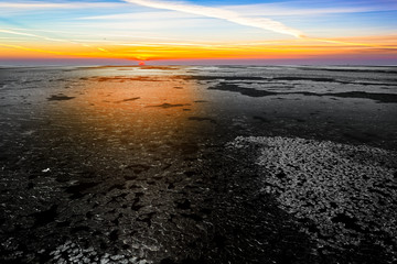 Fototapeta na wymiar Landscape with frozen sea at beautiful winter sunrise.