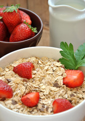 bowl of cereal with milk and strawberries