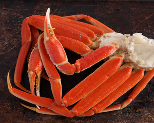 Crab legs on brown background - 64911031