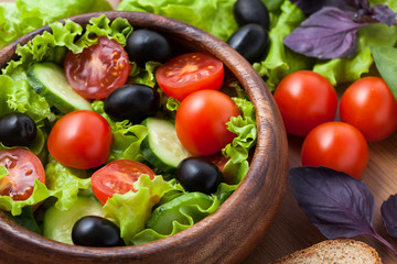 Salad on wooden plate.