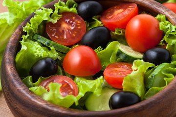 Obraz na płótnie Canvas Salad on wooden plate.