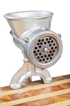 old iron meat grinder mounted on table