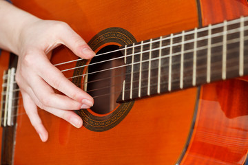 Fototapeta premium female hand playing acoustic guitar