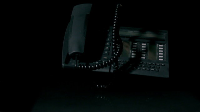 Telephone falling on black background