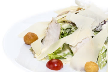 meat salad with cheese and herbs on a white plate