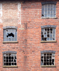 Broken Windows in an old building - 64917289