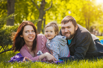 Fototapeta premium mother and father are plaing with their daughter