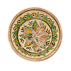 ancient plate from ceramics with ornament on a white background
