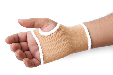 Male hand gesturing wearing blue neoprene wrist support over whi