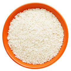 White dry uncooked grain rice in orange bowl