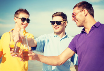 group of male friends having fun on the beach