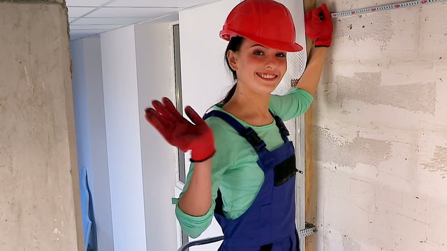 Happy woman in builder uniform indoor.