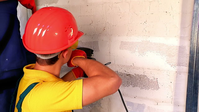 	Happy group people in builder uniform indoor