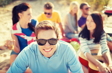smiling man in sunglasses on the beach